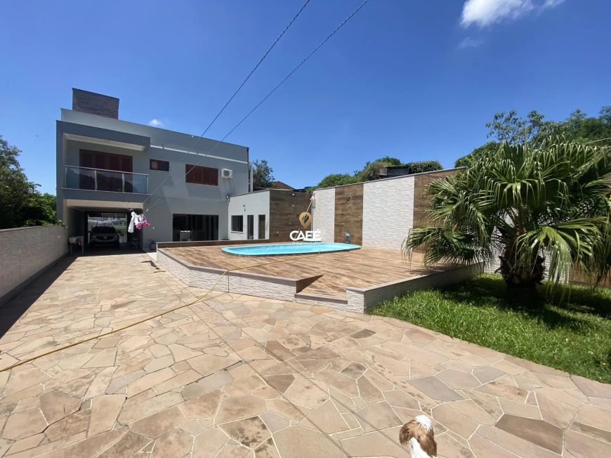 Casa com 3 dormitórios , extenso pátio com piscina.
